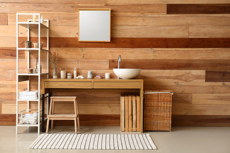 Interior of bathroom with sink, table and shelving unitの写真素材