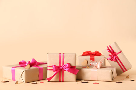 Stack of gift boxes and decor on color background. Valentine's Day celebration