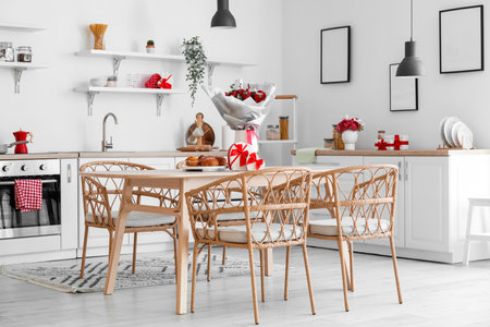 Interior of kitchen decorated for Valentine's Day with flowers, dining table and countersの写真素材