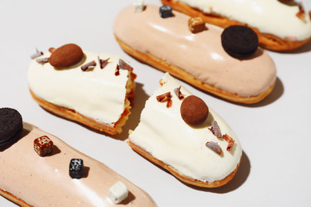 Delicious eclairs on light background