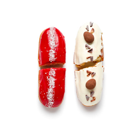 Halves of delicious eclairs isolated on white background