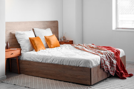 Interior of light bedroom with wooden tables and vasesの写真素材