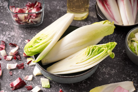 Bowl of fresh endive on grunge background
