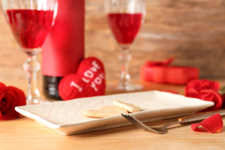 Plate with tasty cookies on wooden table, closeup. Valentine's Day celebrationの写真素材