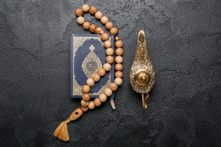 Aladdin lamp of wishes, Koran and prayer beads for Ramadan on dark backgroundの写真素材