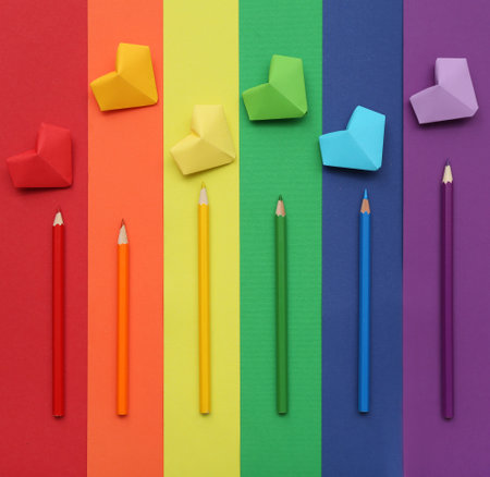 Pencils and hearts on paper sheets in colors of LGBT flag. Valentine's Day celebrationの写真素材