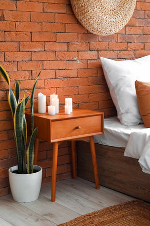 Burning candles on wooden table in the bedroomの写真素材