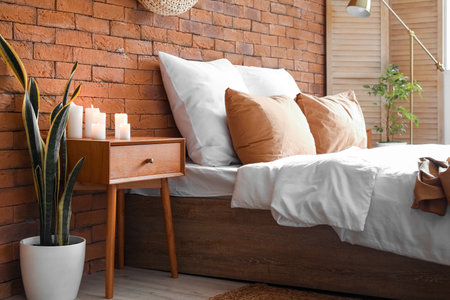 Burning candles on wooden table in the bedroomの写真素材