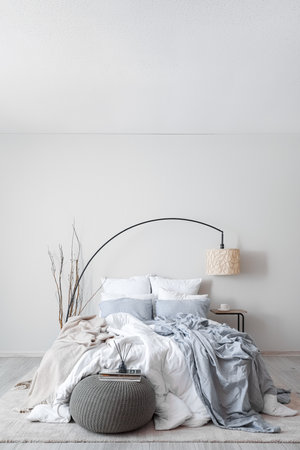 Interior of modern bedroom with lamp and tree branchesの写真素材