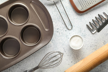 Utensils for baking and bowl of sugar on light background, closeupの写真素材