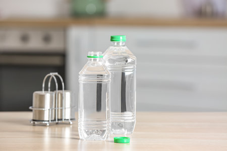 Bottles of water on table in kitchen, closeup