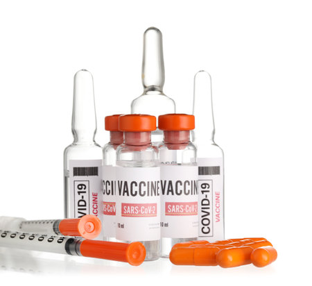 Different vaccines for immunization against COVID-19 and syringes on white backgroundの写真素材