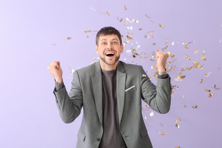 Happy man and falling confetti on color background