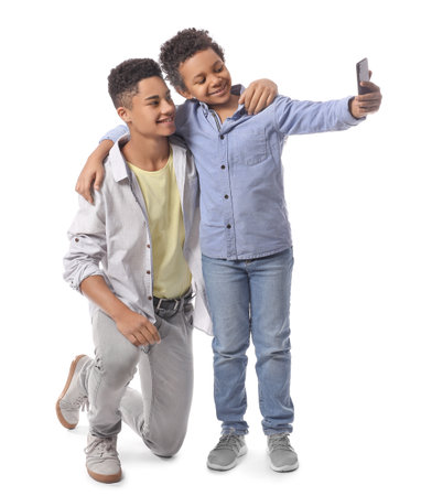 African-American boys taking selfie on white backgroundの写真素材