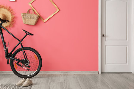 Modern bicycle near color wall in roomの写真素材