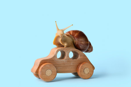 Snail and figure of car on color backgroundの写真素材