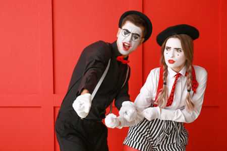 Male and female pantomimists on color backgroundの写真素材