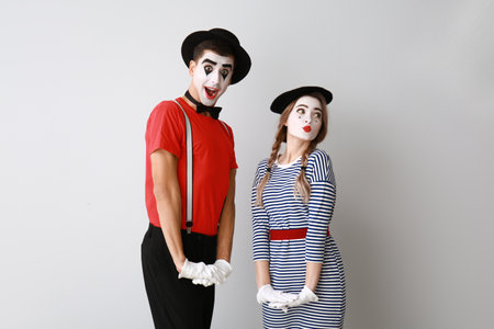 Male and female pantomimists on gray backgroundの写真素材