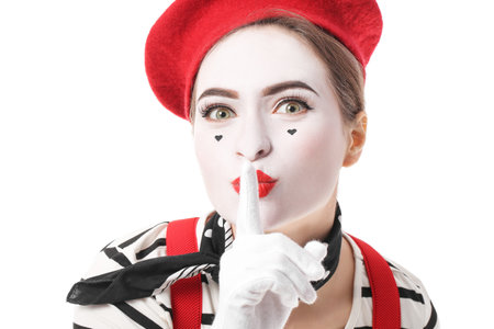 Female pantomimist showing silence gesture on white backgroundの写真素材