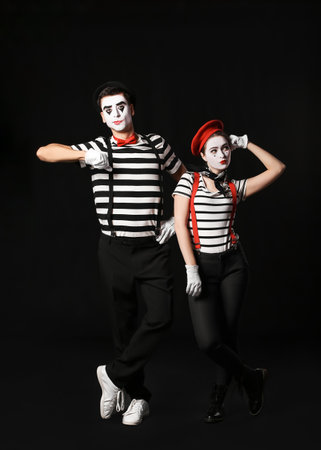 Male and female pantomimists on dark backgroundの写真素材