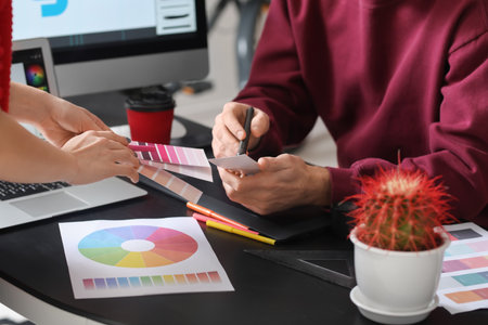 Male designer with colleague working in office