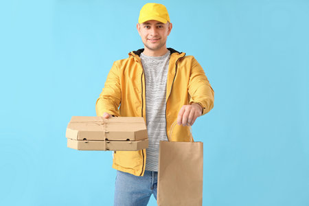 Courier of food delivery service on color backgroundの写真素材