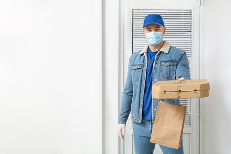 Courier of food delivery service near customer's doorの写真素材