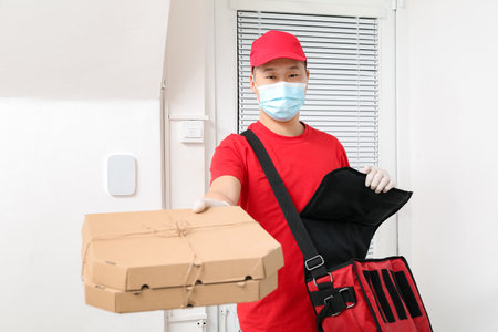 Courier of food delivery service near customer's door