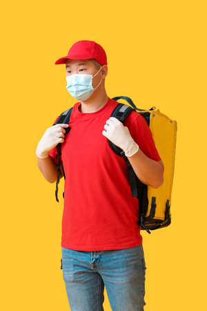 Courier of food delivery service on color backgroundの写真素材