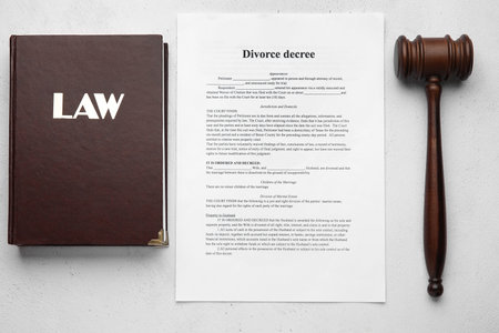 Judge's gavel with law book and divorce decree on light backgroundの写真素材