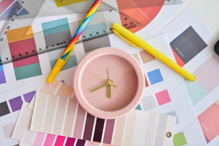Alarm clock and palette samples on table