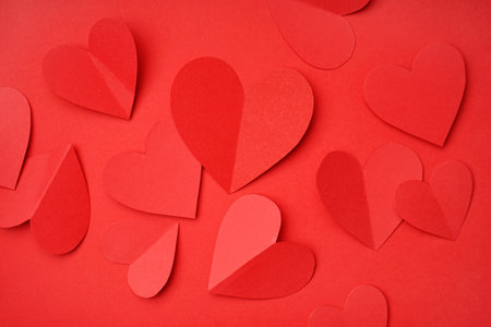 Beautiful paper hearts on red background. valentine's day celebration