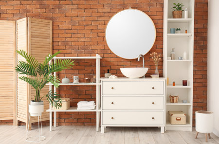 Interior of bathroom with ceramic sink, drawers and shelving unit