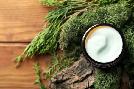 Jar of cream with green moss and tree bark on wooden backgroundの写真素材