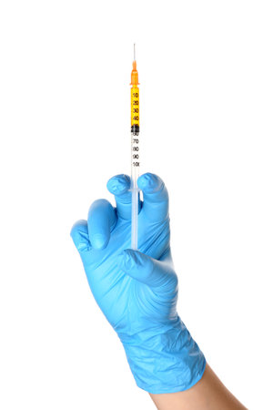 Female doctor with medical syringe on white backgroundの写真素材