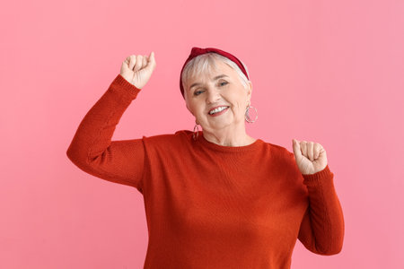 Portrait of stylish senior woman on color background