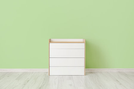 Modern chest of drawers near color wall in roomの写真素材