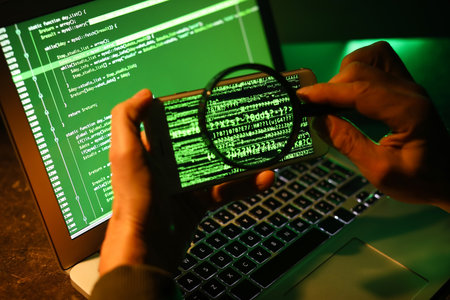 Hacker with mobile phone, magnifier and computer