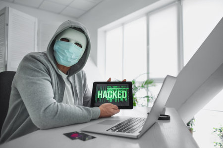 Hacker using computers in room
