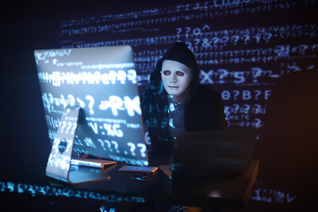 Hacker using computer in dark room
