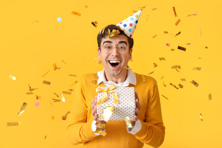 Happy man celebrating birthday on color backgroundの写真素材