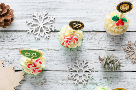 Composition with tasty Christmas cupcakes on wooden backgroundの写真素材