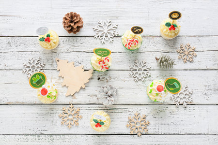 Composition with tasty Christmas cupcakes on wooden backgroundの写真素材
