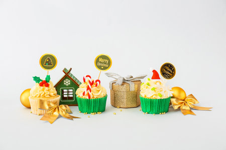 Tasty Christmas cupcakes on light backgroundの写真素材