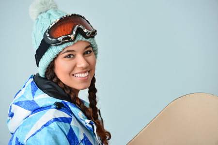 Female snowboarder on color backgroundの写真素材
