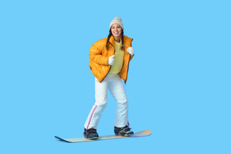 Female snowboarder on color backgroundの写真素材