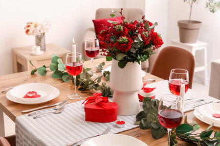 Table setting for Valentine's Day with beautiful flowers in dining roomの写真素材