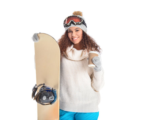 Female snowboarder with coffee on white backgroundの写真素材