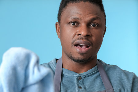 African-American man with rag on color backgroundの写真素材