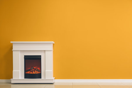 Beautiful fireplace near color wall in roomの写真素材